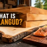 Plangud Estonian wood planks stacked in a rustic workshop beside a cedar grilling board and hand tools
