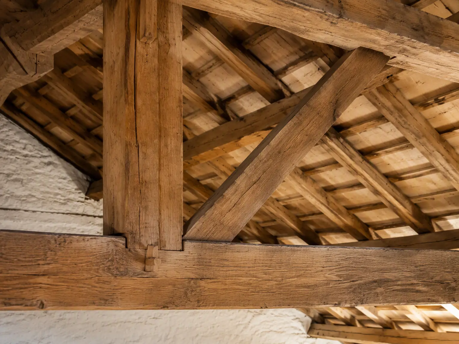 Diagonal wooden Windstrebe brace connecting structural members in a traditional timber roof.